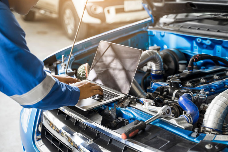 a mechanic repairing a car engine