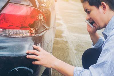 Man is calling insurance company for claiming his car crash damaged